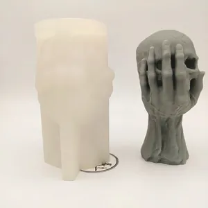 3D skull candle silicone mold with hand holding head for DIY Halloween crafts