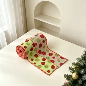 Detail of burlap Christmas ribbon with red and green polka dots and wired edges