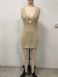 Close-up of beige crochet knit beach dress featuring a deep V-neck and silver metal ring