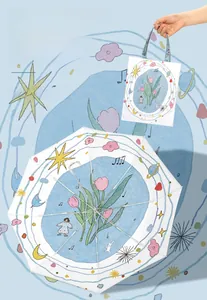 Detail of white umbrella with tulip floral illustrations and matching storage bag