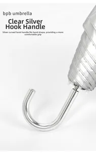 Close-up of ergonomic silver curved metal handle on a foldable sun and rain umbrella