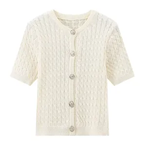 Detail of cream short sleeve cardigan with cable knit texture and silver buttons