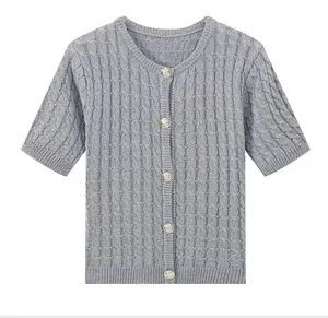 Close-up of gray short-sleeve knit cardigan showing cable knit texture and metal buttons