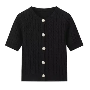 Detail of black cable knit cardigan with vintage silver buttons and round neck