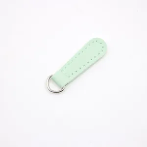 Detailed view of mint green PU leather zipper puller with fine white stitching