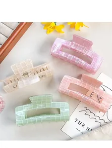 Close-up of iridescent PVC hair claws with mosaic texture in pastel color set