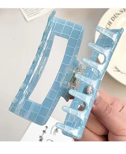 Detail of light blue checkerboard hair claw clip with a hollow rectangular structure