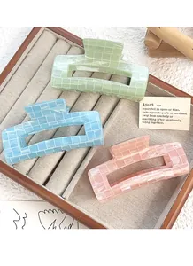 Three-piece iridescent hair claw clip set in pastel green, blue, and peach colors