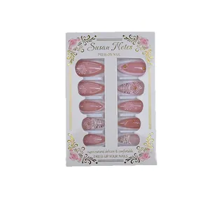 Pink press-on nails with 3D floral designs, zebra stripes and gold rhinestones