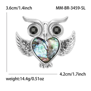 Silver owl brooch with abalone shell heart and size markings on white background