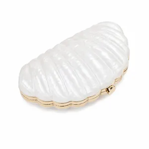 Elegant shell-shaped pearl white evening clutch with gold metal frame and shell texture