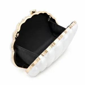 Elegant white shell shaped acrylic evening clutch with gold metal frame and ball clasp