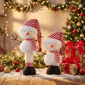 Detail of plush Christmas snowmen with striped hats in a festive home setting