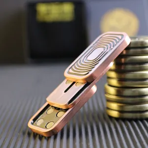 Macro detail of the brushed red copper fidget slider with concentric CNC engravings