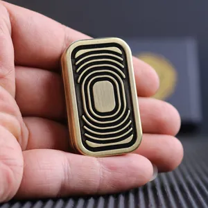Macro detail of silver EDC magnetic push slider toy with layered wave texture in hand