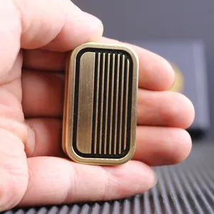 Macro shot of a vintage brass EDC haptic slider with textured metallic finish and black stripes
