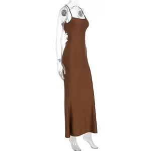 Detailed view of brown satin slip maxi dress with cross-back tie design and open back