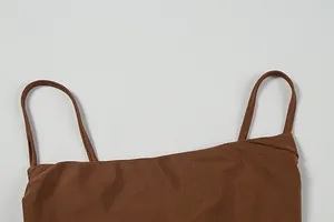 Detail shot of a dark brown satin knit dress showing thin straps and fabric texture