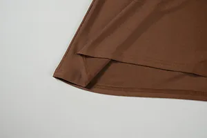 Detail shot of brown satin dress hem featuring high-quality double-line stitching craft