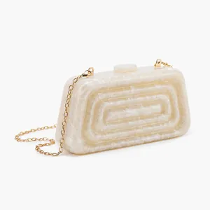 Detail of acrylic clutch with marble texture, tiered design, and gold chain strap