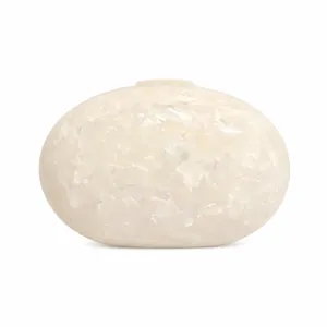 Macro shot of oval white pearl acrylic evening bag showing marble texture and clasp