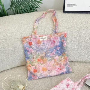 Close-up of floral lace tote bag showing mesh texture and colorful flower patterns