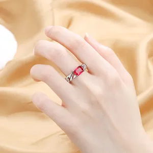 Elegant Cuban chain ring in silver with a rectangular red zircon stone on finger
