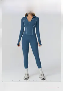Detail of navy yoga set with white contrast stitching, thumbholes, and slim-fit zipper jacket