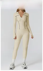 Front view of creamy apricot three-piece yoga set with black contrast trim detail