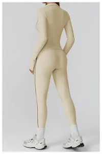 Detail view of khaki slim-fit yoga set with high-waist pants and contrast side stripes