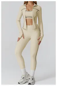 Three-piece beige yoga set with black piping detail including jacket, bra and leggings