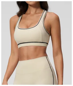 Detail of beige yoga set with contrast black stitching and high-waist elastic fabric