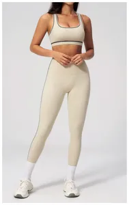 Close-up of contrast binding on cream yoga set with sports bra and high-waist leggings