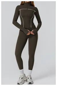 Detail of high-stretch olive green yoga set featuring white contrast piping and zipper