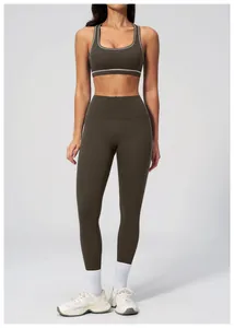 Detail view of contrast stitching on olive green high-waisted yoga leggings and sports bra