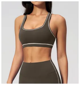 Detail of olive yoga set with contrast stitching on sports bra and high-waist leggings