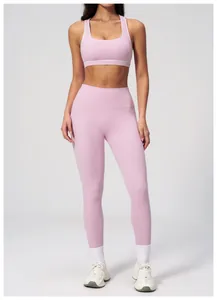 Detail of pink three-piece yoga set featuring U-neck sports bra and high waist leggings