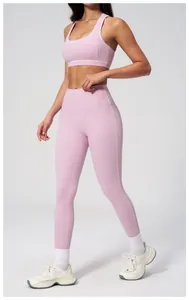 Detail of mauve pink yoga set with white trim stitching on bra and high waist leggings