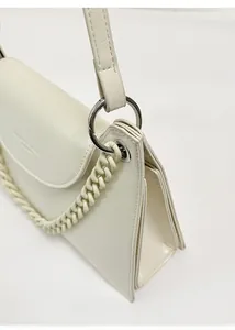 Detailed side view of cream white chain bag showing accordion pleats and texture
