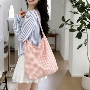 Detail view of the pink gingham canvas tote bag with wide shoulder strap