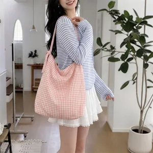Detail of soft pink and white checkered canvas tote bag with spacious interior design