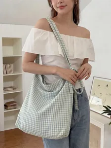 Blue plaid canvas tote bag with adjustable shoulder straps for daily casual style