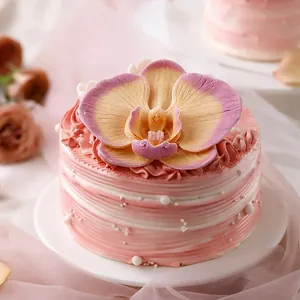 Artistic round mousse cake with pink cream texture and large orchid silicone mold