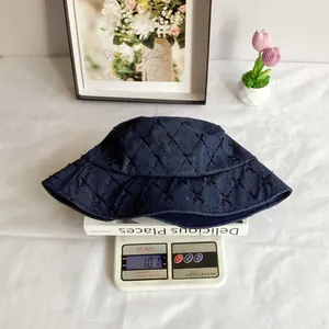 Quilted denim bucket hat with black sequins and beads showing a weight of 101g