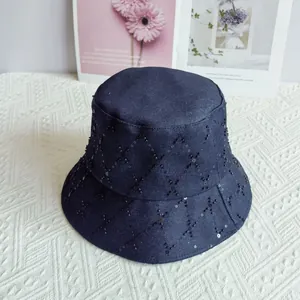 Close-up of quilted denim bucket hat featuring black sequins and diamond pattern