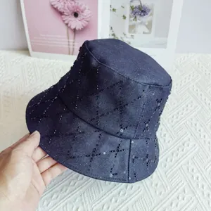 Close-up of quilted denim bucket hat featuring black sequins and diamond stitching