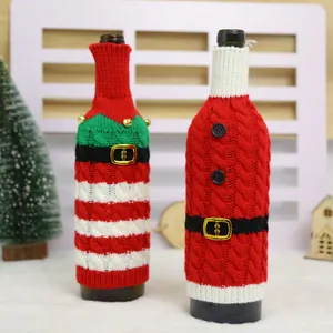 Festive knitted Christmas wine bottle covers with striped patterns and gold bell details