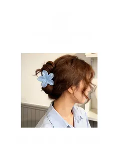 Light blue plumeria flower hair claw clip shown on long wavy hair for styling