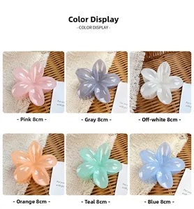 Detail view of 8cm colorful flower claw clips in pink, grey, blue, and orange