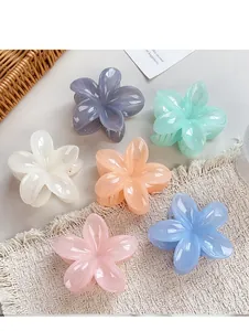Detailed view of six colorful glossy flower hair claws in a variety of soft candy colors